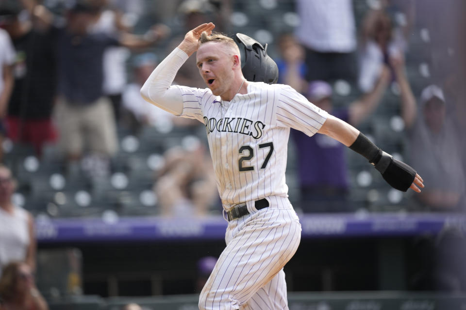 Colorado Rockies' Trevor Story celebrates as he scores the winning run on a walkoff single hit by pinch-hitter Charlie Blakmon in the ninth inning of a baseball game Wednesday, June 16, 2021, in Denver. The Rockies won 8-7 to sweep the three-game set. (AP Photo/David Zalubowski)