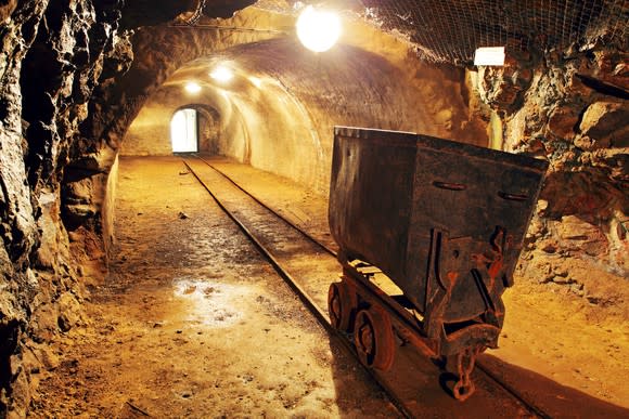 Handtruck on rails in a gold mine tunnel