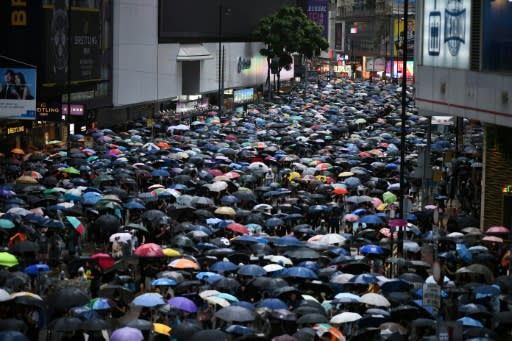 Large crowds marched through torrential rain in unsanctioned rallies on both sides of Victoria Harbour on October 6, 2019