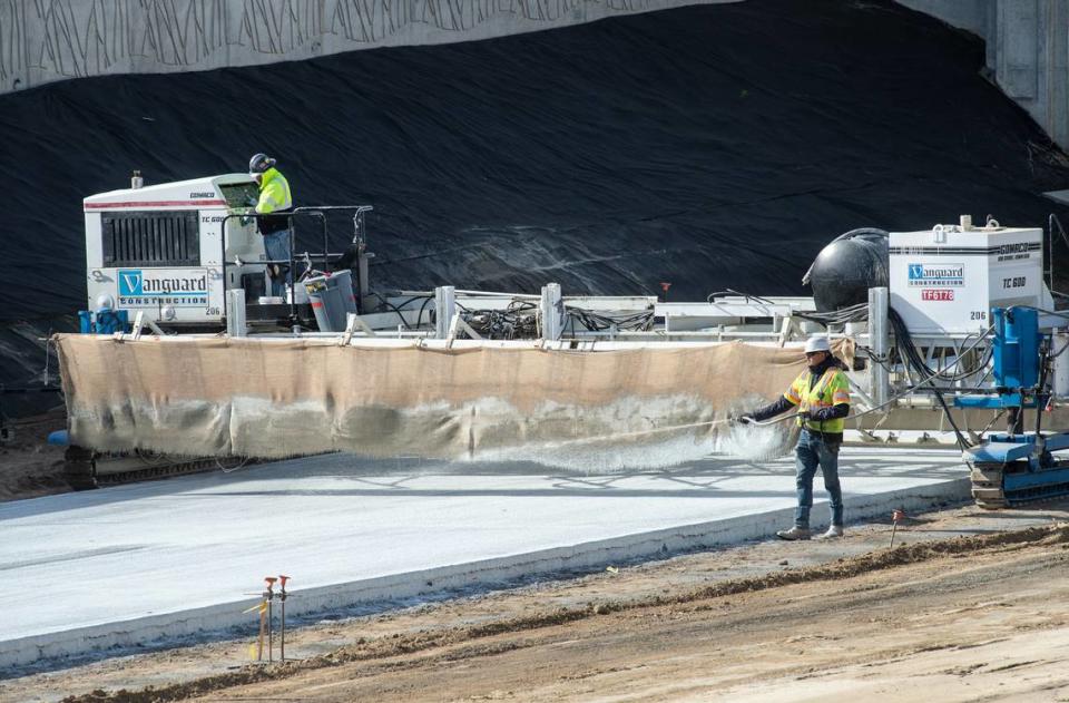 A crew works on paving a section of the new Highway 132 bypass in Modesto, Calif., on Friday, Jan. 21, 2022.