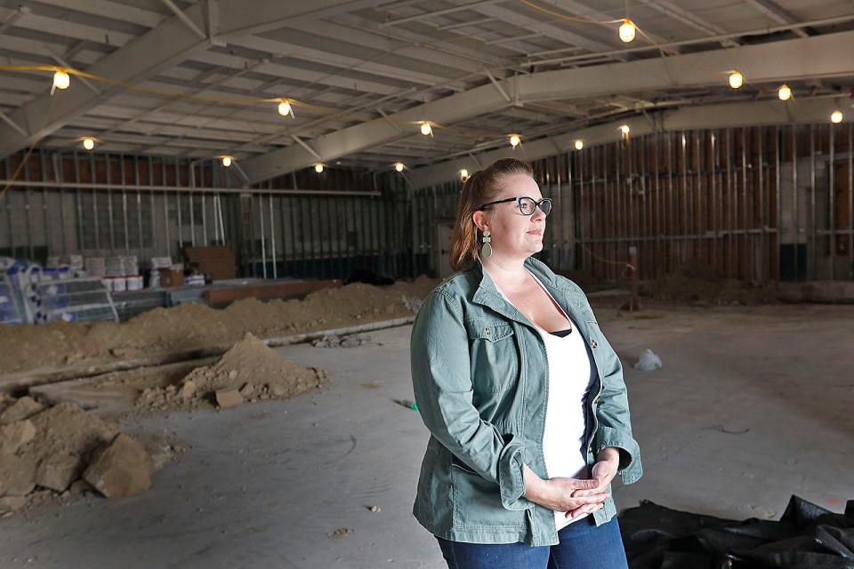 Caitlyn Woodward-Samson, vice president of retail for Native Sun cannabis company, is pictured inside a closed Pier One Imports store in Braintree, Mass. which will be converted to a medical marijuana dispensary.