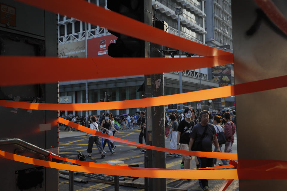 In this Saturday, Oct. 12, 2019, file photo, protesters are seen on a cross road during a protest in Hong Kong. The protests that started in June over a now-shelved extradition bill have since snowballed into an anti-China campaign amid anger over what many view as Beijing's interference in Hong Kong's autonomy that was granted when the former British colony returned to Chinese rule in 1997. (AP Photo/Kin Cheung, File)