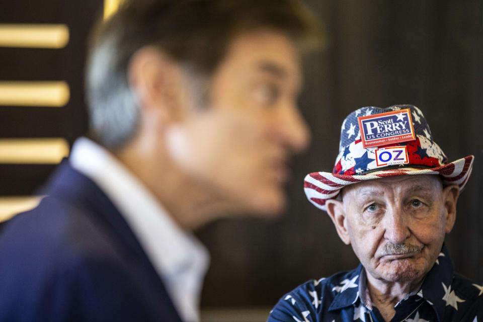 Republican nominee for U.S. Senate, Dr. Mehmet Oz, center, drops by The Capitol Diner, Friday, Aug. 12, 2022, in Swatara Township, Pa. (Sean Simmers/The Patriot-News via AP)