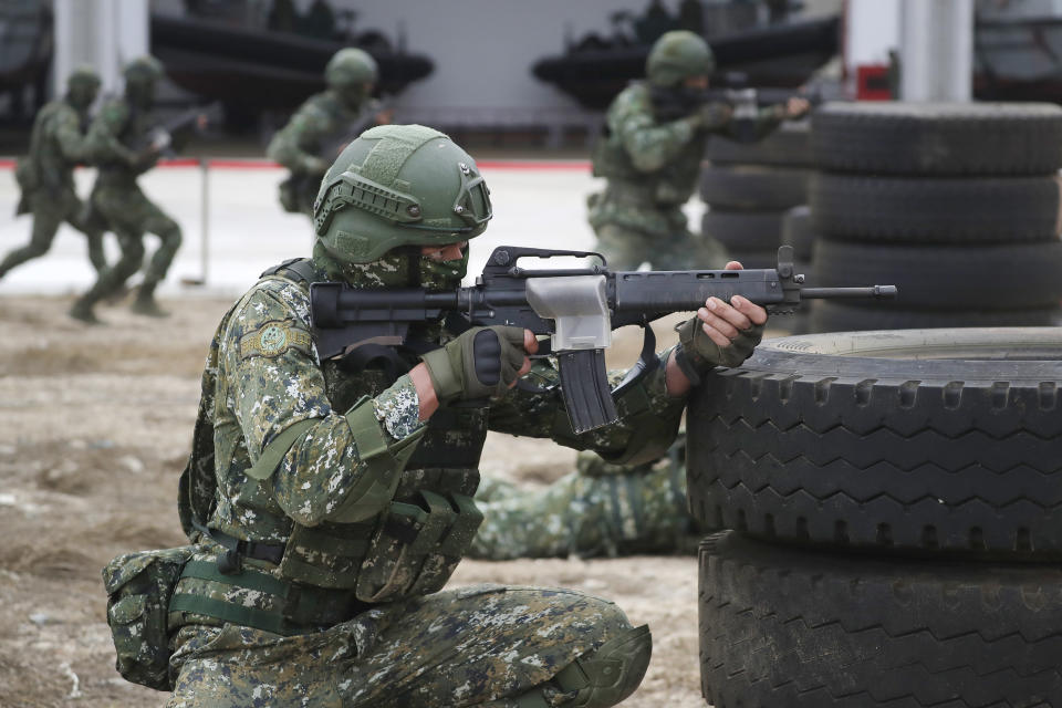 Soldiers perform moving shooting as Taiwan President Tsai Ing-wen inspects at the Penghu Magong military base in outlying Penghu Island, Taiwan, Friday, Dec. 30, 2022. (AP Photo/ Chiang Ying-ying)