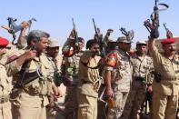 Military policemen raise their weapons at their barracks in Yemen's northwestern city of Saada April 1, 2015. REUTERS/Naiyf Rahma