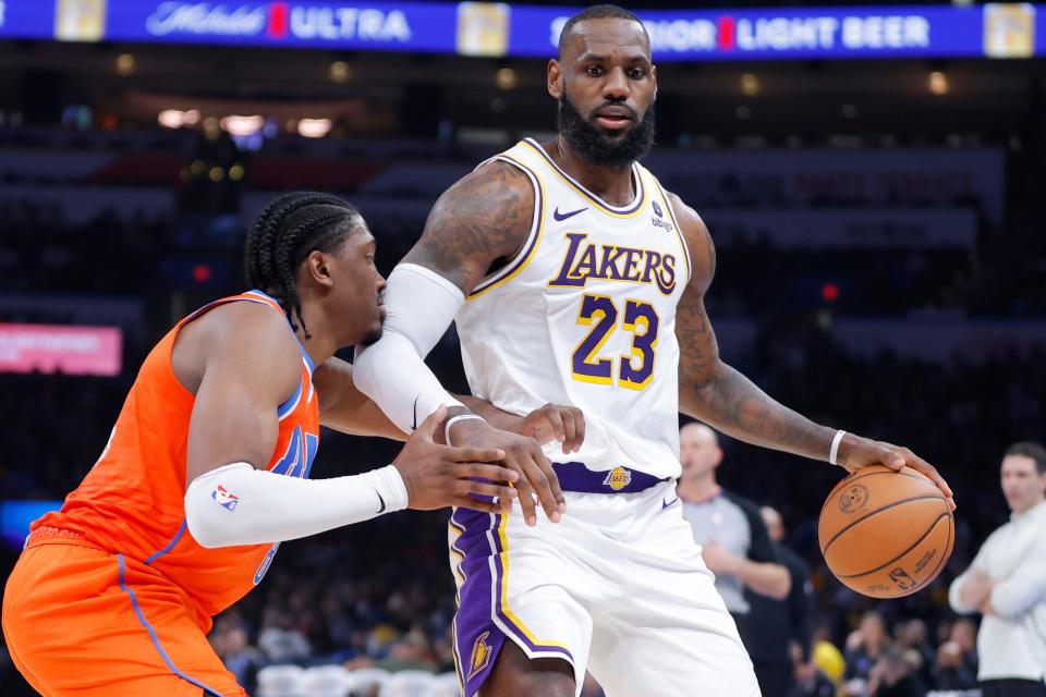 Thunder forward Jalen Williams (8) defends Lakers forward LeBron James (23) during Saturday's game at Paycom Center.