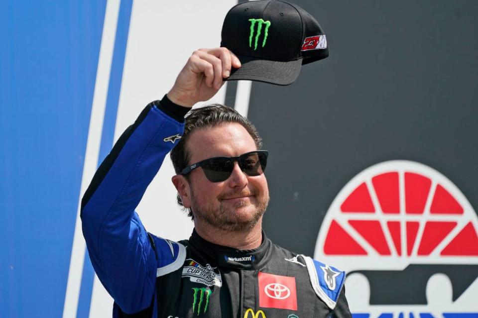 FILE - NASCAR Cup Series driver Kurt Busch tips his cap prior to the NASCAR Cup Series auto race at the New Hampshire Motor Speedway, Sunday, July 17, 2022, in Loudon, N.H. Busch will miss the start of NASCAR’s playoffs with concussion-like symptoms that have sidelined him six weeks, so 23XI Racing on Thursday, Aug. 25, 2022, withdrew the medical waiver that was holding Busch’s spot in the playoffs. (AP Photo/Charles Krupa, File)