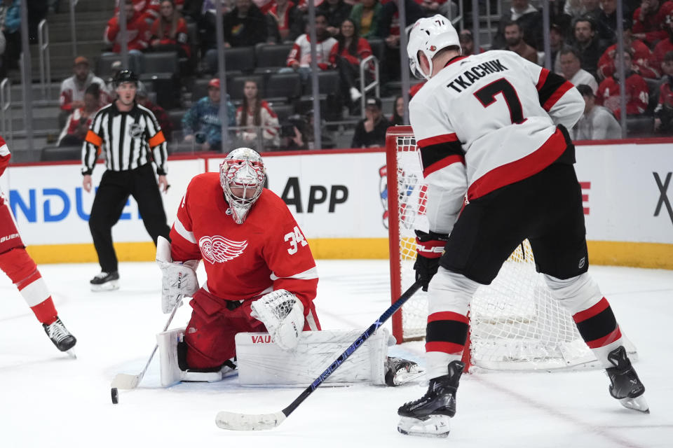 Detroit Red Wings goaltender Alex Lyon (34) stops a Ottawa Senators left wing Brady Tkachuk (7) shot in the first period of an NHL hockey game Wednesday, Jan. 31, 2024, in Detroit. (AP Photo/Paul Sancya)