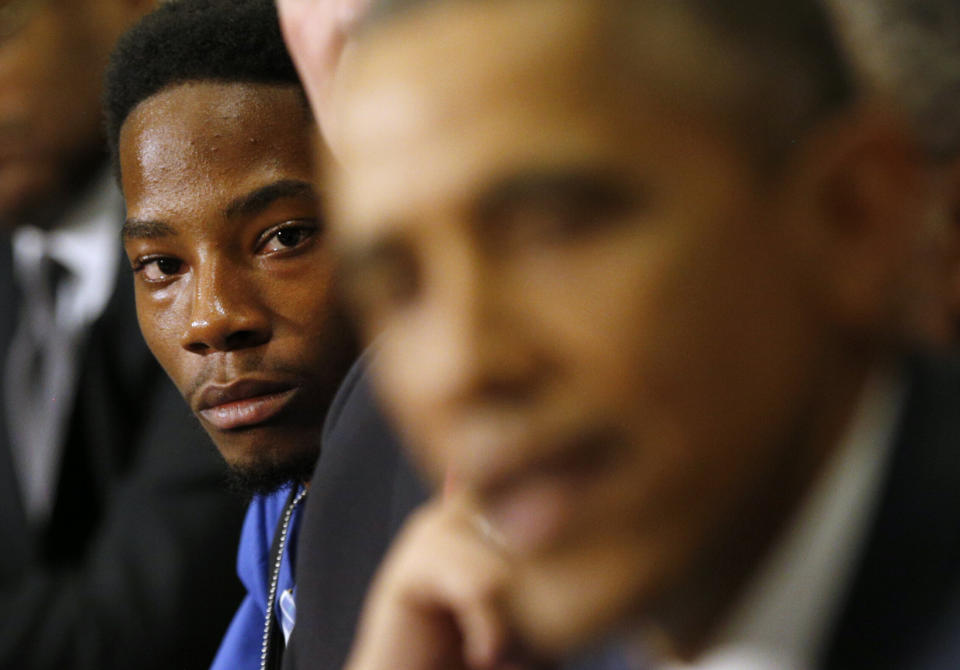 Youth leader Rasheen Aldridge of the Ferguson Commission listens as President Barack Obama speaks at the White House on Dec. 1, 2014. (Photo: Kevin Lamarque / reuters)