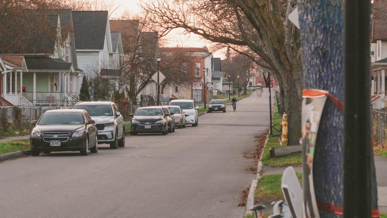 A man rides a bike down Weld Street.