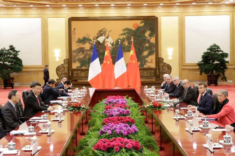 China's President Xi Jinping and French President Emmanuel Macron attend a meeting in Beijing