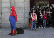 <p>A man dressed as Spider-Man performs for money as tourists look at the main square in Madrid, May 23, 2013. (AP Photo/Andres Kudacki) </p>