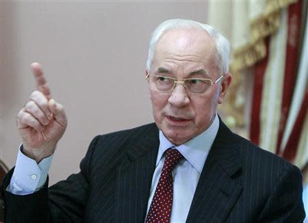 Ukraine's Prime Minister Mykola Azarov gestures during a meeting with foreign journalists in Kiev in this November 26, 2013 file photo. REUTERS/Gleb Garanich/Files