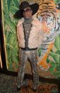 <p>Porter for a shearling cream bomber jacket, striped turtleneck, black wide-brimmed hat, snake-print trousers and boots to the TOMMYNOW after party at member's club Annabel's during London Fashion Week. </p>