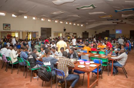 Residents eat a meal in the dinning hall at the Agahozo-Shalom Youth Village (ASYV) built to rehabilitate children who lost their families in the 1994 Rwandan genocide, in Rwamagana, Eastern Province of Rwanda April 1, 2019. Picture taken April 1, 2019. REUTERS/Jean Bizimana