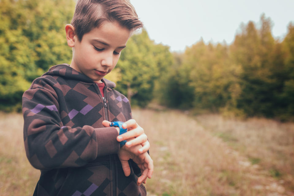 a little boy checking his watch