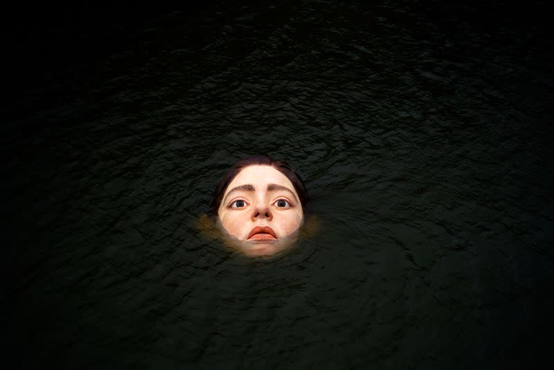 A fibreglass sculpture entitled 'Bihar' is submerged in the Nervion river in Bilbao