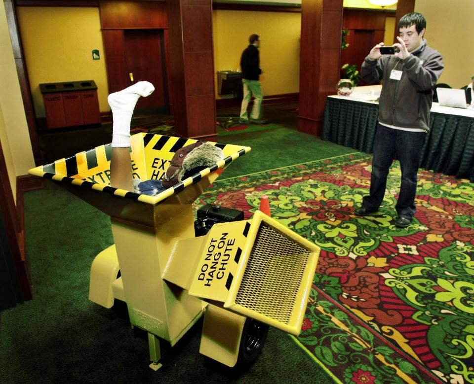 In this photo taken April 19, 2011, Mitch Highman, of Fargo, takes a picture of a one-of-a-kind wood chipper on display during the 2011 North Dakota Travel Industry Conference at the Holiday Inn in Fargo, N.D. The chipper was made by Brian Matson and his father to resemble the one in the movie "Fargo" which was also a custom-made unit. When the movie Fargo debuted in 1996, many residents in the North Dakota city were not fans of the film’s dark humor, not to mention the heavy accents. But the fame and cash from the movie eventually brought many Fargo residents around. Now, 16 years later, Fargo awaits the debut of a new cable television show by the same name. And many residents are less apprehensive about how their hometown will be portrayed this time around. (AP Photo/The Forum, Dave Wallis)