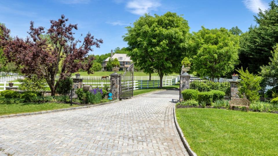 The private driveway leading to the horse facilities and separate apartment - Credit: Douglas Elliman