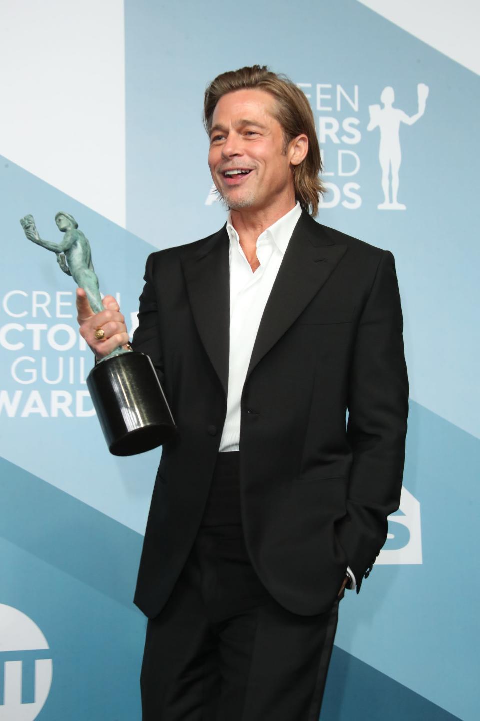 In the press room, Brad Pitt shows off his SAG award for outstanding performance by a male actor in a supporting role for "Once Upon a Time in Hollywood."