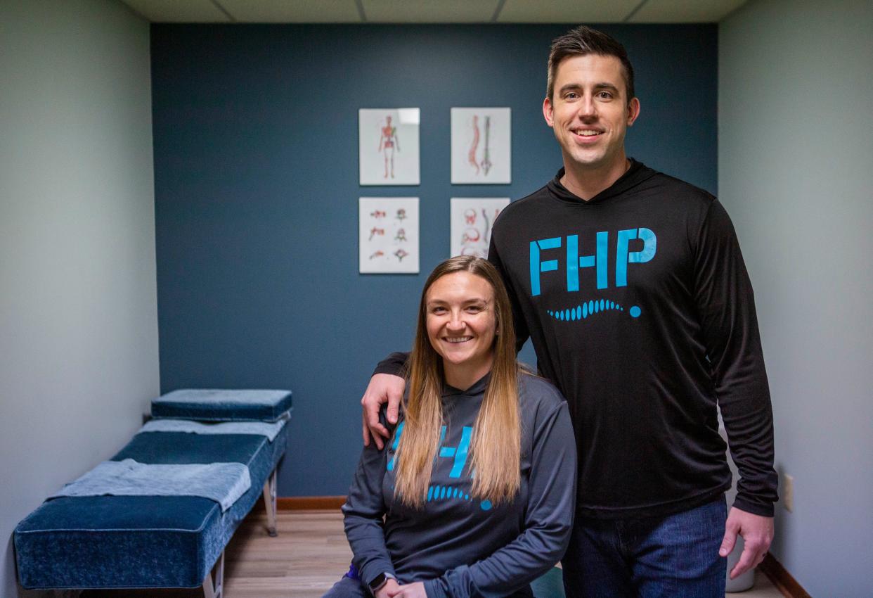 Doctors Cory and Cassie Keesee, owners and chiropractors at Fortitude Health and Performance, sit on one of the chiropractic tables in their office in Johnstown, Ohio on March 24, 2022.