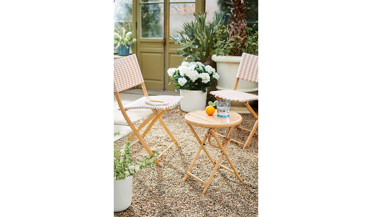Pair of bistro chairs and accompanying table in a garden 