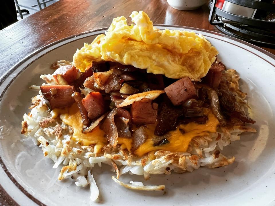 Railroad Bill's Dining Car features the Burlington Sleeper, a hash brown dish with bacon, ham, onion and American cheese, plus two eggs any style.