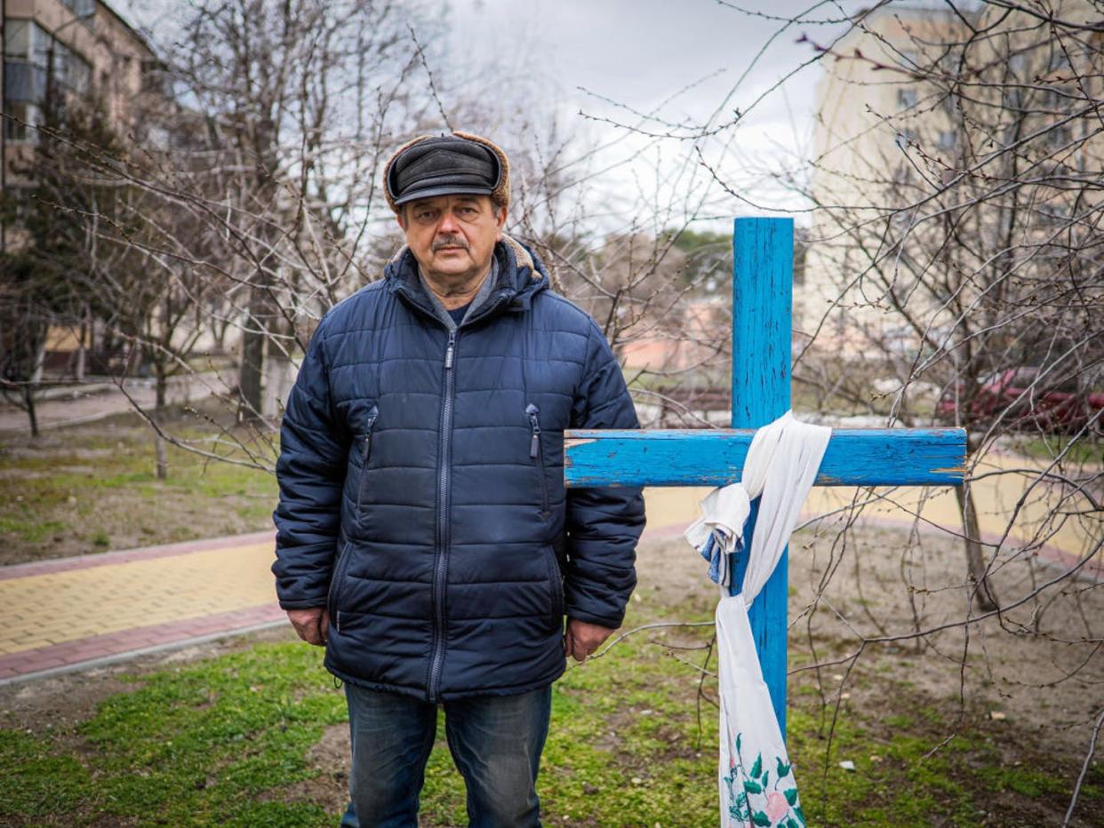 <span class="caption">A man identified only as Viktor shows his neighbor's grave in Bucha, Ukraine. It was too dangerous to go to the cemetery.</span> <span class="attribution"><a class="link " href="https://www.gettyimages.com/detail/news-photo/viktor-who-survived-the-russian-occupation-in-bucha-shows-a-news-photo/1239825447?adppopup=true" rel="nofollow noopener" target="_blank" data-ylk="slk:Jana Cavojska/SOPA Images/LightRocket via Getty Images;elm:context_link;itc:0;sec:content-canvas">Jana Cavojska/SOPA Images/LightRocket via Getty Images</a></span>