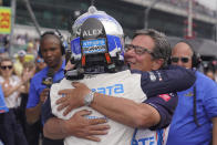 Alex Palou, of Spain, gets a hug from Barry Wasner, front right, during qualifications for the Indianapolis 500 auto race at Indianapolis Motor Speedway, Sunday, May 22, 2022, in Indianapolis. (AP Photo/Darron Cummings)