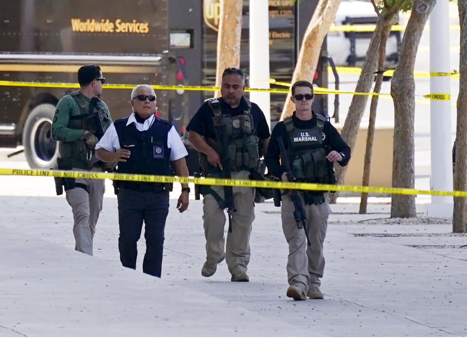 Federal law enforcement personnel patrol outside the Sandra Day O'Connor Federal Courthouse Tuesday, Sept. 15, 2020, in Phoenix. A drive-by shooting wounded a federal court security officer Tuesday outside the courthouse in downtown Phoenix, authorities said. The officer was taken to a hospital and is expected to recover, according to city police and the FBI, which is investigating. (AP Photo/Ross D. Franklin)