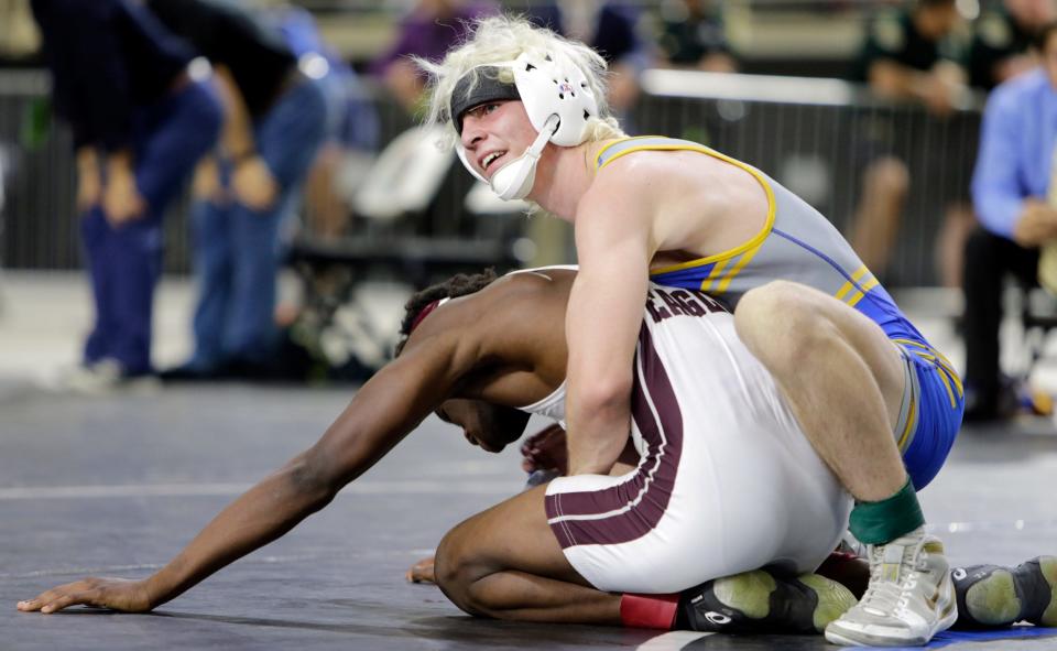 Charlotte High&#39;s Andrew Austin smiles as he watches the clock tick down during his Class 2A 126-pound final at the FHSAA Championships on Saturday evening at Silver Spurs Arena in Kissimmee. Austin won 14-0 over Brandon High&#39;s Darrell Tabor.