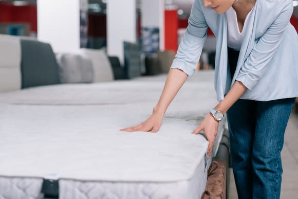 Woman shopping for a mattress.