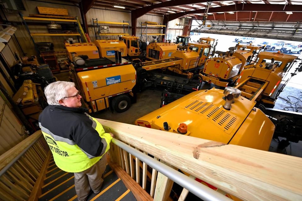 Worcester Regional Airport Director Andy Davis surveys some of the airport's snow removal equipment on Monday.