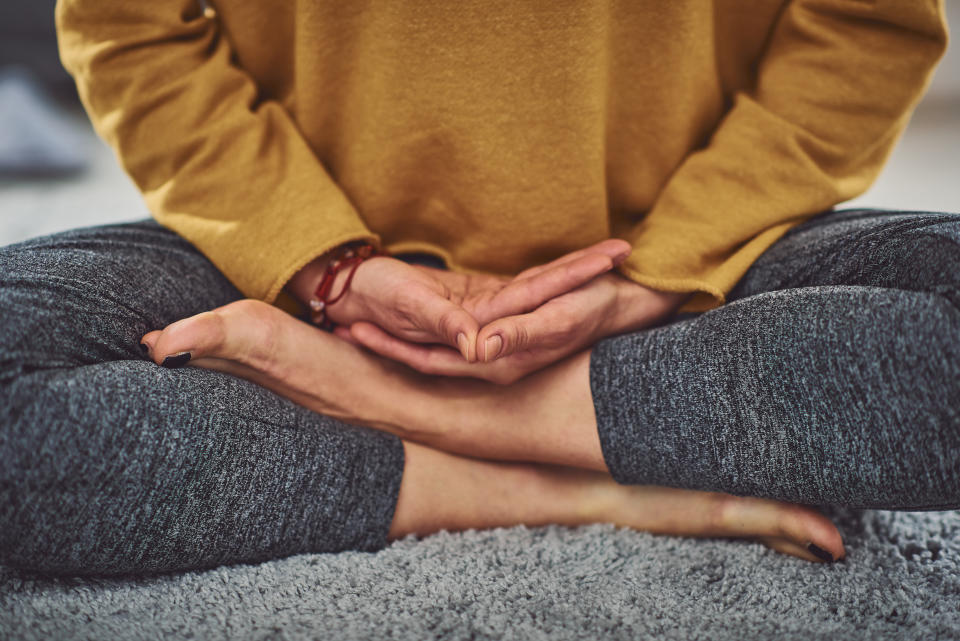 Close up of caucasian woman meditating indoors.