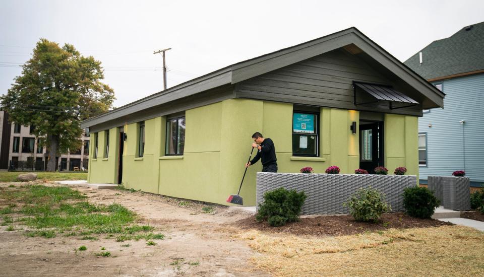 Fernando Bales, 35, of Pontiac, build lab manager of Citizen Robotics, also has the distinction of being the builder of record for Michigan's first 3D-printed house in Detroit. He tidies up around the 1.000-square-foot house on Monday, Sept. 25, 2023.