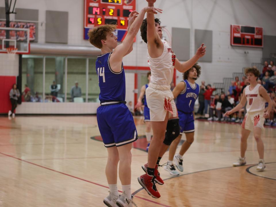 Gunter's Brady Harris shoots over Pottsboro's Aaron Massie during the Tigers' victory in District 11-3A action. Harris finished with a team-high 11 points.