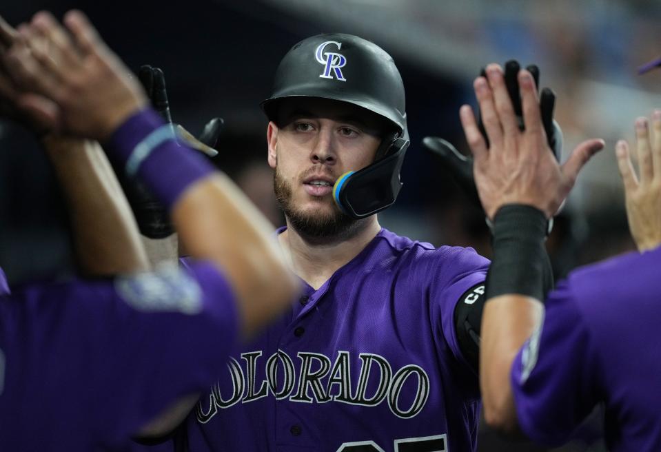 C.J. Cron is congratulated after hitting a two-run home run against the Marlins on July 21. A 2022 All-Star, Cron hit 29 homers and drove in a career-high 102 runs last season with the Rockies.