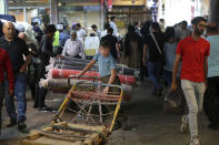 A young worker takes a break on his cart at the old main bazaar in Tehran, Iran, Sunday, June 23, 2019. (AP Photo/Ebrahim Noroozi)