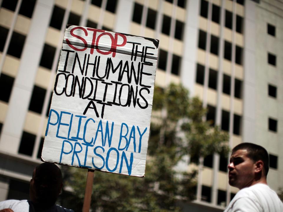 Jose Flores, 27, (L) and Eddie Ramirez, 24, attend a rally in Los Angeles, California August 1, 2011, in support of California inmates who spent weeks on a hunger strike to protest prison conditions. The U.S. has 5 percent of the world's population, 25 percent of the world's prisoners and an incarceration rate five times as high as the rest of the world.