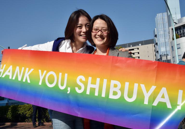 Japanese gay couple Hiroko Masuhara (L) thank Tokyo's Shibuya ward for its decision to issue "partnership" certificates to gay couples, outside the local government office on March 31, 2015