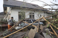 A man inspects the damage at his home in an area affected by the eruption of Mount Semeru in Lumajang, East Java, Indonesia, Sunday, Dec. 5, 2021. The highest volcano on Indonesia’s most densely populated island of Java spewed thick columns of ash, searing gas and lava down its slopes in a sudden eruption triggered by heavy rains on Saturday. (AP Photo/Trisnadi)