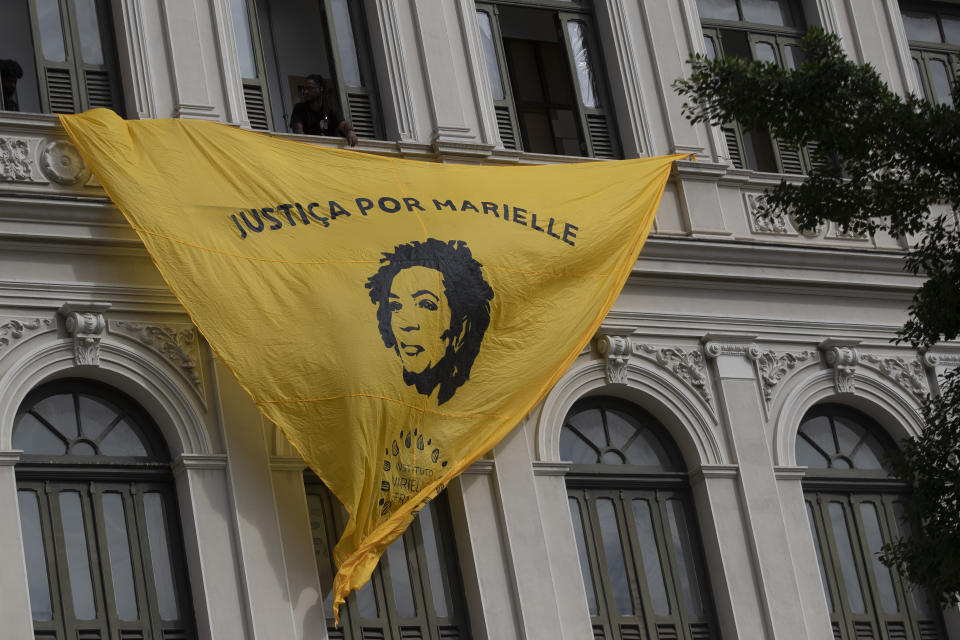 A banner with an image of slain councilwoman Marielle Franco and a message that reads in Portuguese; "Justice for Marielle" hangs on the facade of the Rio Art Museum, marking five years of her assassination, in Rio de Janeiro, Brazil, Tuesday, March 14, 2023. (AP Photo/Bruna Prado)