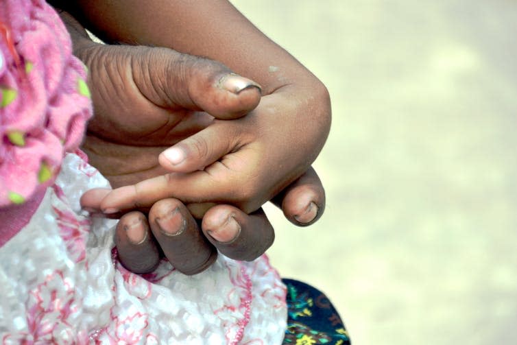 <span class="caption">Muzaffar tenderly held his granddaughter’s hand throughout our conversation.</span> <span class="attribution"><span class="source">Sonja Ayeb-Karlsson</span></span>