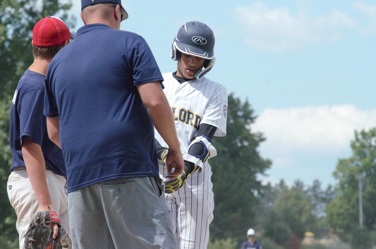 Torino Lamerato hands off his equipment to his coach after successfully reaching base. Lamerato led the Gaylord offense over the five-game stretch, going 8-for-17 (.471 avg) with nine runs scored and five RBI