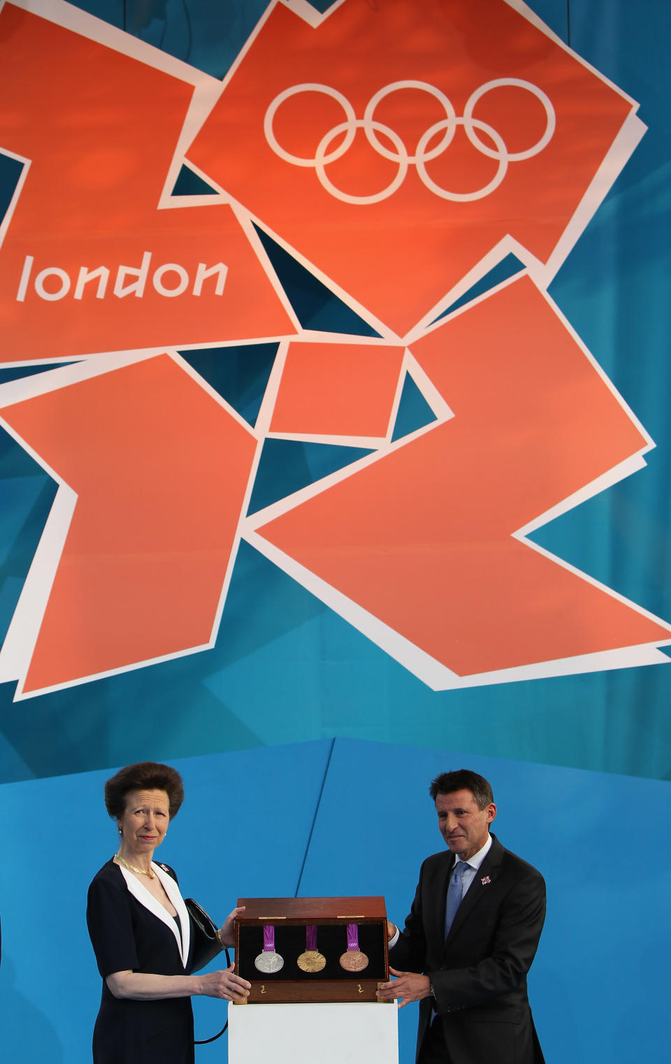 LONDON, ENGLAND - JULY 27: Princess Anne, Princess Royal and LOCOG Chairman Sebastian Coe present the Olympic medals during the' London 2012 - One Year To Go' ceremony in Trafalgar Square on July 27, 2011 in London, England. The one year countdown to the London 2012 Olympic games was marked with a unique ceremony in Trafalgar Square, with IOC President Jacques Rogge inviting the world's athletes to compete in next summer's games. (Photo by Dan Kitwood/Getty Images)