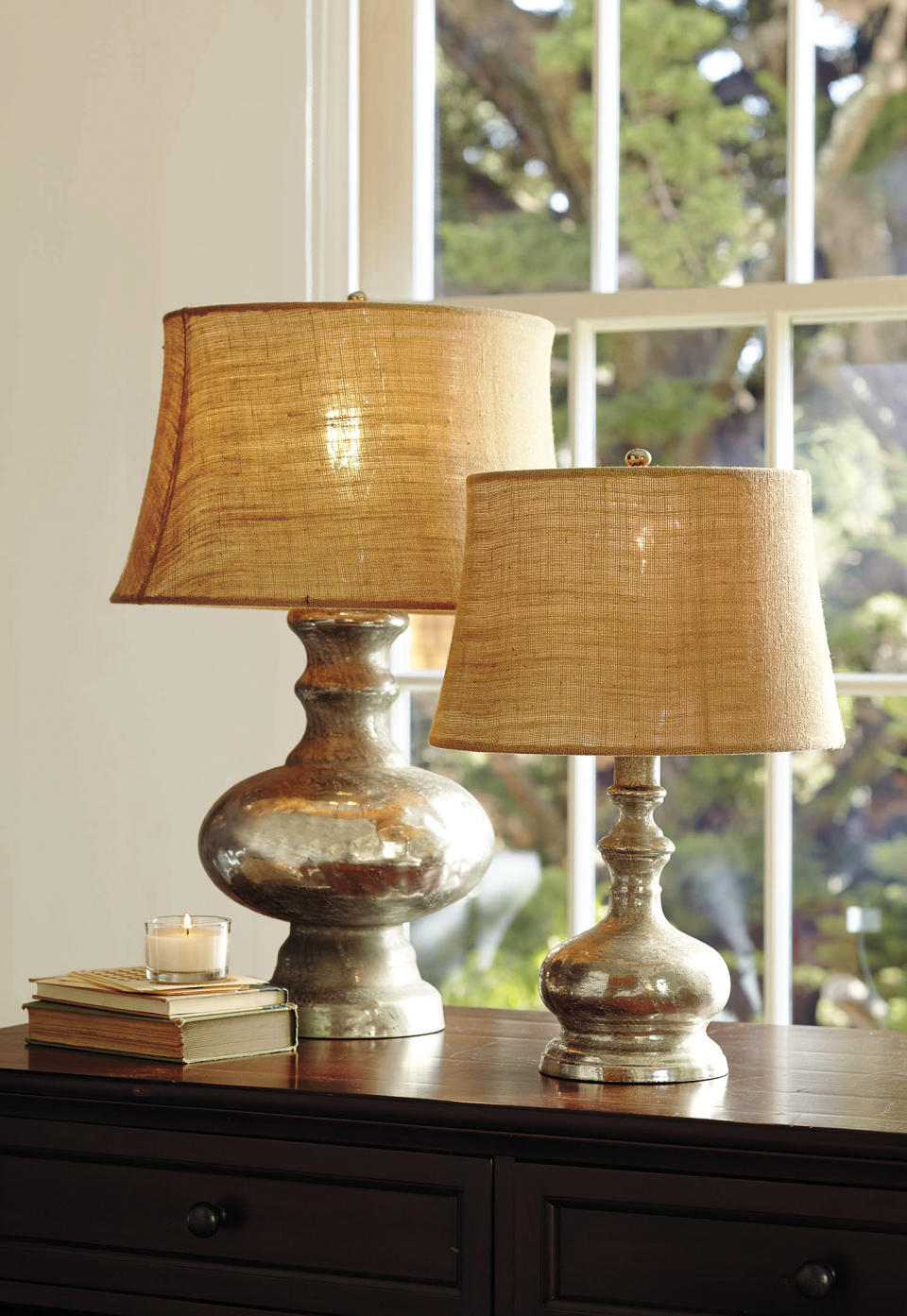 This publicity photo provided by Pottery Barn shows a pair of antique mercury glass lamps. Mercury glass, antiqued or in new hues like copper, grey or slate blue, continues to hold strong for fall. You’ll see it in wall panels, vases, boxes and lamps like these from Pottery Barn.com. (AP Photo/Pottery Barn, John Merkl, Matt Sartain)
