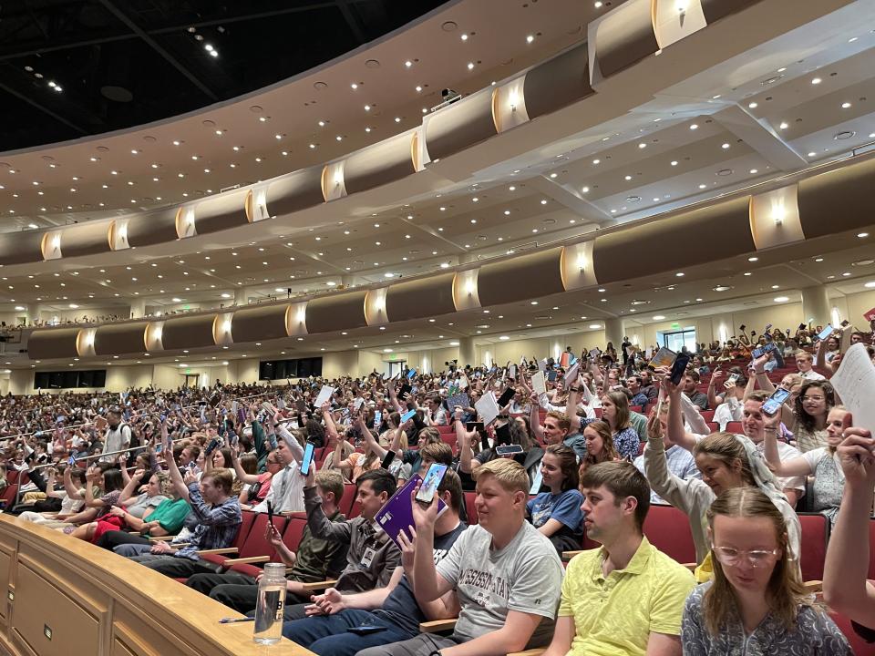 BYU-Idaho students show they are prepared to take notes at the start of the weekly campus devotional.