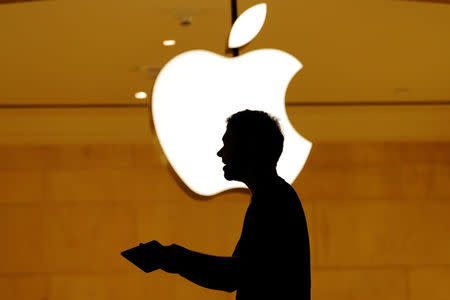 Customers walk past an Apple logo inside of an Apple store at Grand Central Station in New York, U.S., August 1, 2018. REUTERS/Lucas Jackson