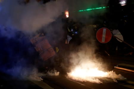 Smoke billows from tear gas canisters during a protest against police violence in Hong Kong