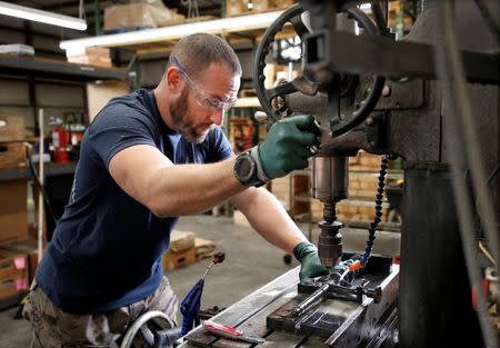 Rodger Brown drills a fitting on a front sight post assembly for an AR-15 style rifle barrel at Spike's Tactical LLC, a gunmaker in Apopka, Florida, U.S. December 10, 2018. Picture taken December 10, 2018. REUTERS/Gregg Newton